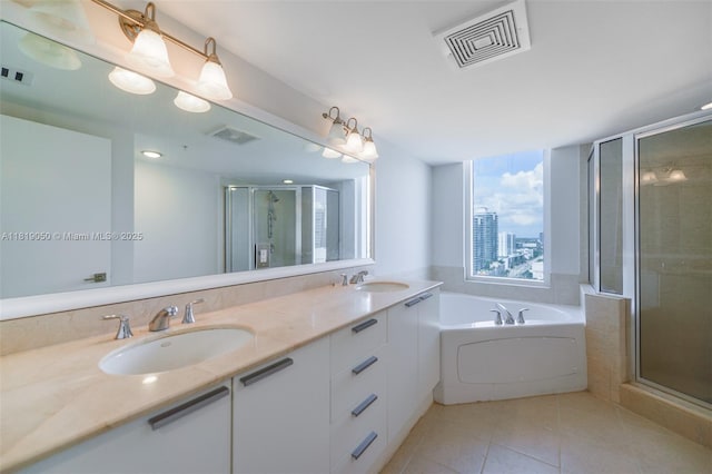 16699 Collins Ave Unit 2107, Sunny Isles Beach, FL 33160 - bathroom featuring tile patterned flooring, a stall shower, a garden tub, and double vanity