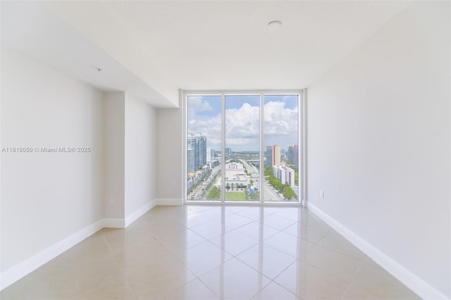 16699 Collins Ave Unit 2107, Sunny Isles Beach, FL 33160 - unfurnished room with expansive windows, a city view, and light tile patterned flooring