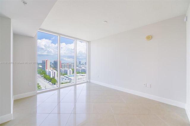 16699 Collins Ave Unit 2107, Sunny Isles Beach, FL 33160 - unfurnished room with a view of city, light tile patterned flooring, healthy amount of natural light, and expansive windows