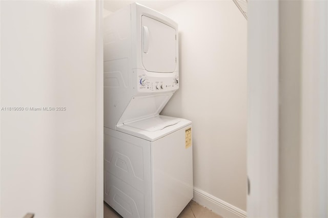 16699 Collins Ave Unit 2107, Sunny Isles Beach, FL 33160 - washroom featuring stacked washer / dryer and light tile patterned floors