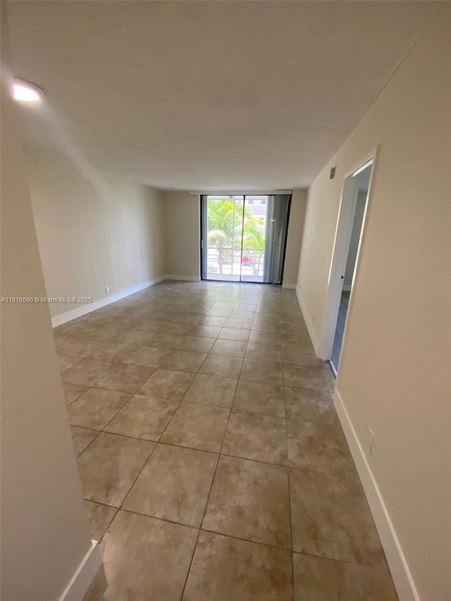 2935 NE 163rd St Unit 3P, North Miami Beach, FL 33160 - tiled spare room with baseboards