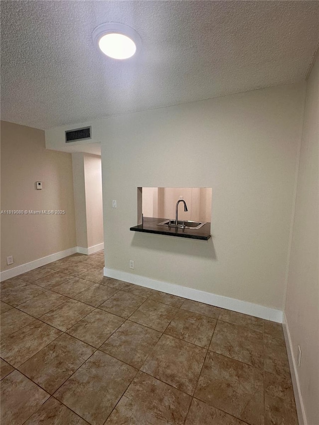 2935 NE 163rd St Unit 3P, North Miami Beach, FL 33160 - empty room with a textured ceiling and tile patterned flooring