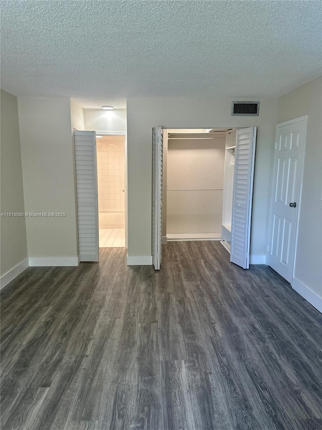 2935 NE 163rd St Unit 3P, North Miami Beach, FL 33160 - unfurnished bedroom featuring dark wood-style floors, a closet, and a textured ceiling