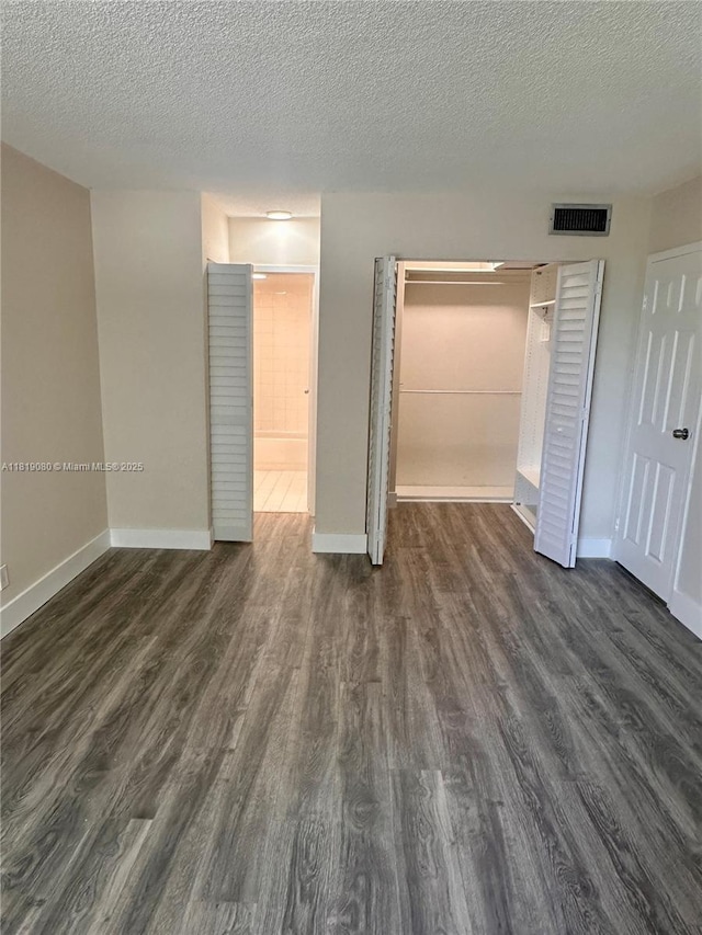 2935 NE 163rd St Unit 3P, North Miami Beach, FL 33160 - unfurnished bedroom featuring dark wood finished floors, a closet, and a textured ceiling