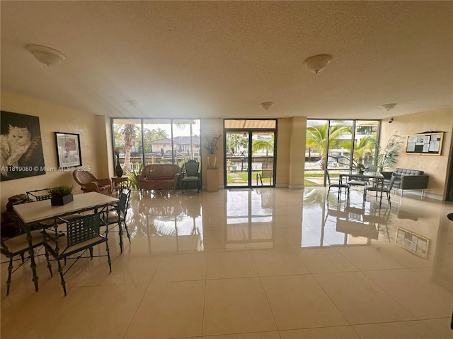 2935 NE 163rd St Unit 3P, North Miami Beach, FL 33160 - dining space featuring floor to ceiling windows, tile patterned flooring, and a textured ceiling