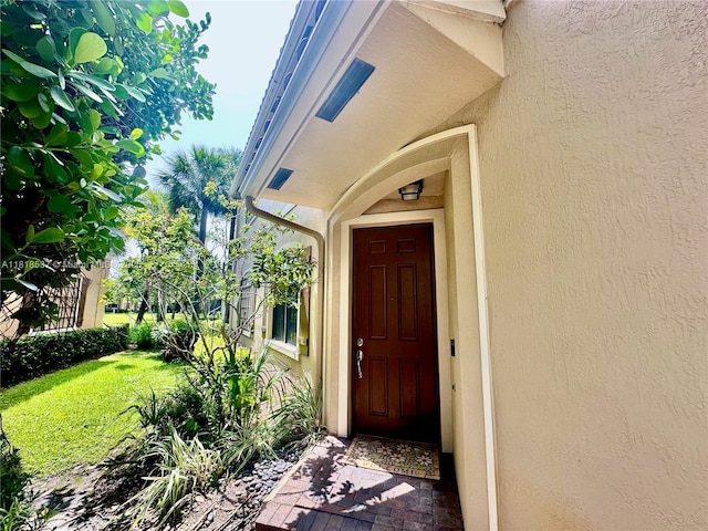 119 Riverwalk Cir E, Plantation, FL 33325 - view of exterior entry with stucco siding and a lawn
