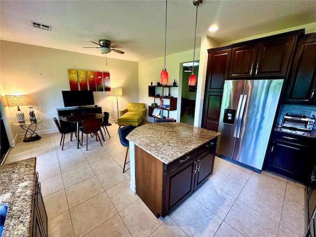 119 Riverwalk Cir E, Plantation, FL 33325 - kitchen featuring stainless steel fridge with ice dispenser, ceiling fan, pendant lighting, light stone counters, and a textured ceiling