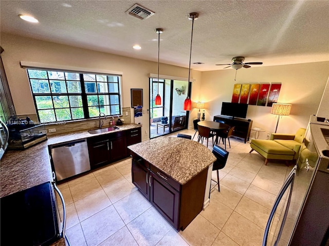 119 Riverwalk Cir E, Plantation, FL 33325 - kitchen with stainless steel dishwasher, ceiling fan, a textured ceiling, a breakfast bar area, and recessed lighting