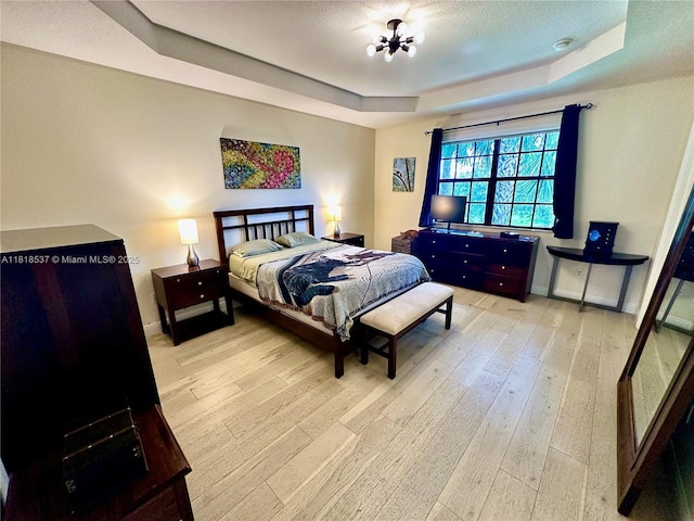 119 Riverwalk Cir E, Plantation, FL 33325 - bedroom featuring a tray ceiling and wood-type flooring