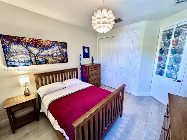 119 Riverwalk Cir E, Plantation, FL 33325 - bedroom with light wood-type flooring, a closet, and a chandelier