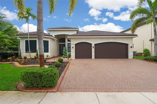 5478 SW 189th Ave, Miramar, FL 33029 - mediterranean / spanish house with an attached garage, decorative driveway, stucco siding, and a tile roof