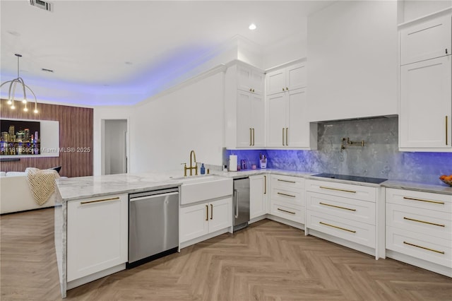 5478 SW 189th Ave, Miramar, FL 33029 - kitchen with stainless steel dishwasher, a peninsula, black electric stovetop, recessed lighting, and white cabinetry