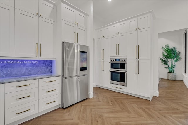 5478 SW 189th Ave, Miramar, FL 33029 - kitchen with stainless steel appliances, white cabinetry, and light stone counters