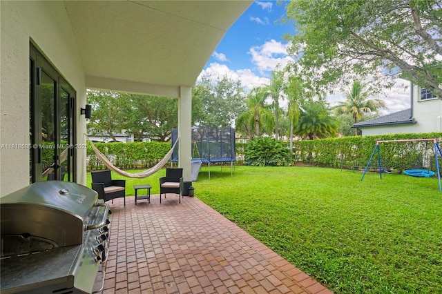 5478 SW 189th Ave, Miramar, FL 33029 - fenced backyard featuring a trampoline, a playground, a grill, and a patio