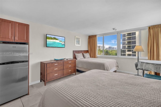 19201 Collins Ave Unit 326, Sunny Isles Beach, FL 33160 - bedroom with freestanding refrigerator, light tile patterned floors, and baseboards