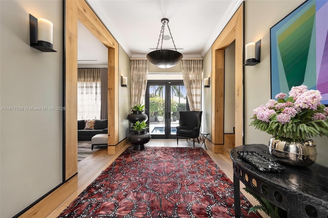 foyer entrance with wood finished floors, french doors, and crown molding
