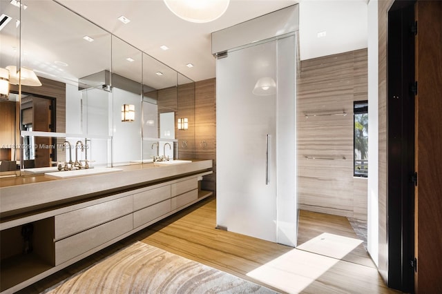 bathroom with double vanity and wood finished floors