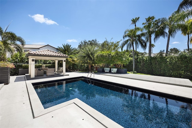swimming pool featuring a gazebo, outdoor lounge area, and a patio area