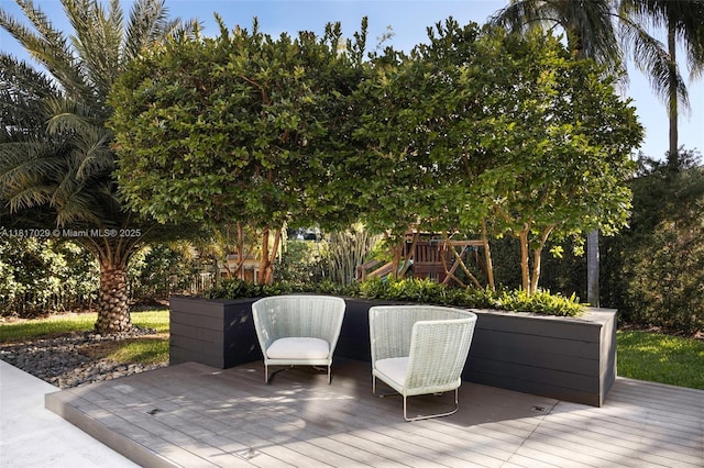 wooden terrace featuring a playground