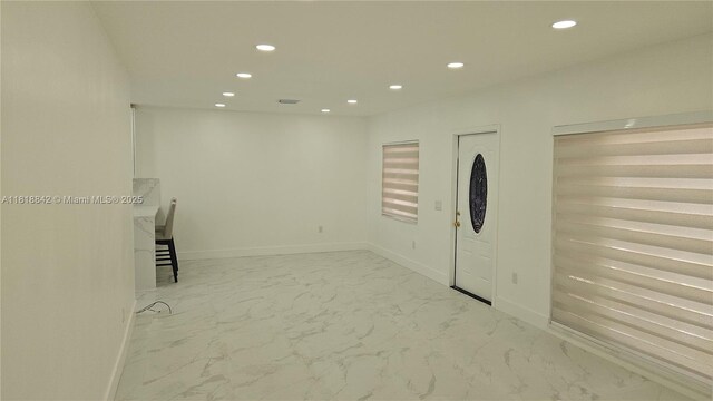 130 W 60th St, Hialeah, FL 33012 - entrance foyer with recessed lighting, marble look tile flooring, and baseboards
