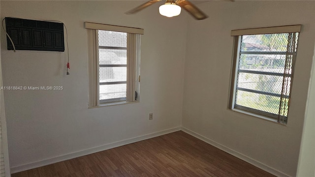 130 W 60th St, Hialeah, FL 33012 - empty room with wood finished floors, a ceiling fan, baseboards, and a wall unit AC