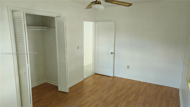 130 W 60th St, Hialeah, FL 33012 - unfurnished bedroom featuring wood finished floors, a closet, and baseboards