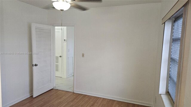 130 W 60th St, Hialeah, FL 33012 - unfurnished bedroom featuring light wood-style flooring, baseboards, and a ceiling fan