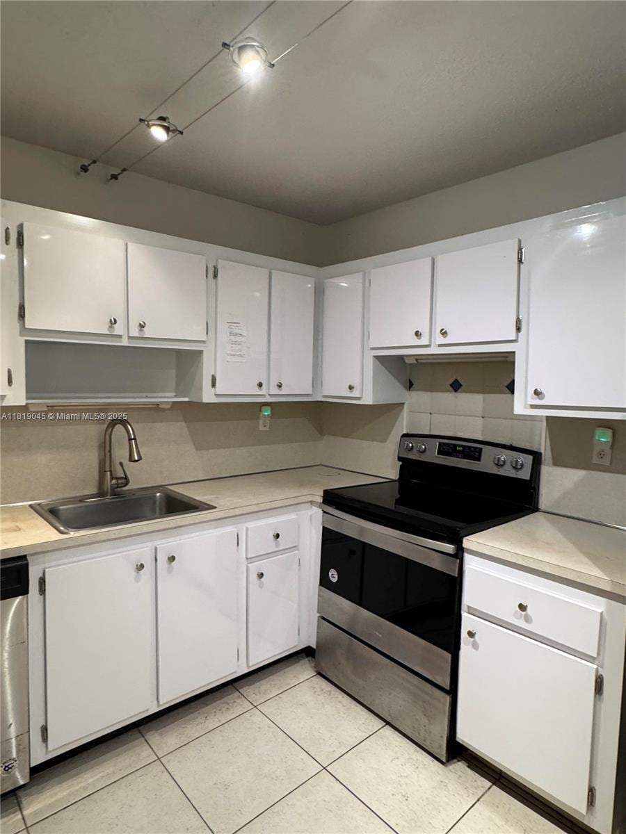 600 Three Islands Blvd Unit 620, Hallandale Beach, FL 33009 - kitchen featuring stainless steel appliances, white cabinets, and light countertops