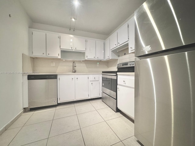 600 Three Islands Blvd Unit 620, Hallandale Beach, FL 33009 - kitchen featuring appliances with stainless steel finishes, white cabinetry, light tile patterned floors, and light countertops