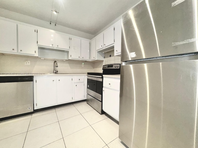 600 Three Islands Blvd Unit 620, Hallandale Beach, FL 33009 - kitchen with stainless steel appliances, white cabinets, light tile patterned floors, and open shelves