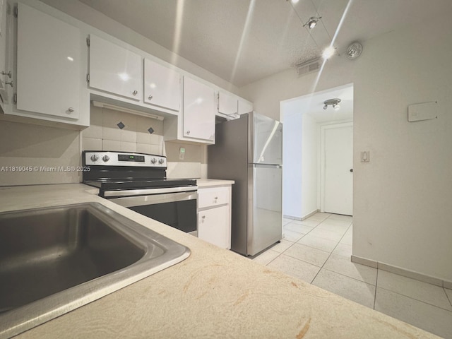 600 Three Islands Blvd Unit 620, Hallandale Beach, FL 33009 - kitchen featuring appliances with stainless steel finishes, light tile patterned floors, white cabinetry, and light countertops