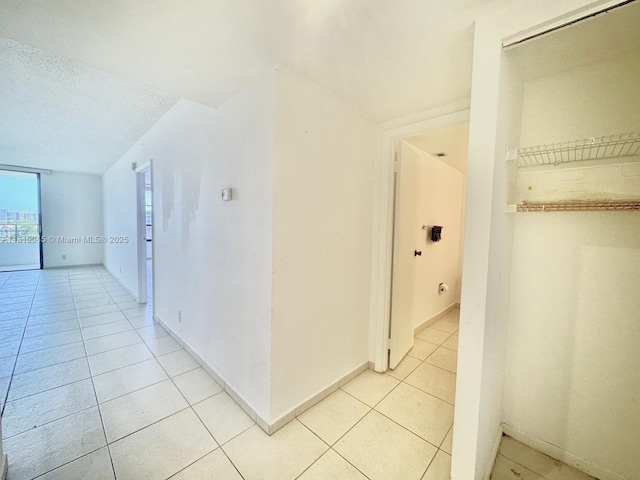 600 Three Islands Blvd Unit 620, Hallandale Beach, FL 33009 - hall featuring light tile patterned floors and a textured ceiling