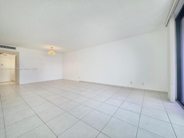 600 Three Islands Blvd Unit 620, Hallandale Beach, FL 33009 - empty room featuring a textured ceiling and light tile patterned flooring