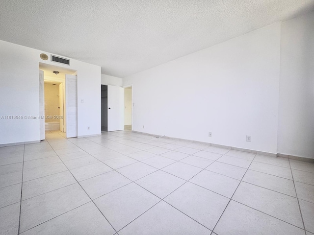 600 Three Islands Blvd Unit 620, Hallandale Beach, FL 33009 - empty room with a textured ceiling and light tile patterned flooring