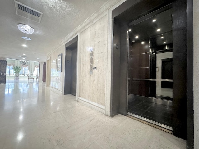 600 Three Islands Blvd Unit 620, Hallandale Beach, FL 33009 - hall featuring elevator, ornamental molding, and a textured ceiling