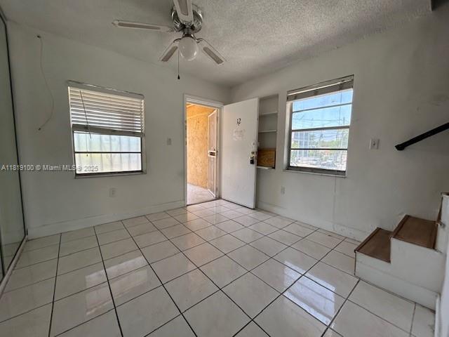 515 SW 3rd St Unit 12, Miami, FL 33130 - empty room with ceiling fan, a textured ceiling, and light tile patterned floors