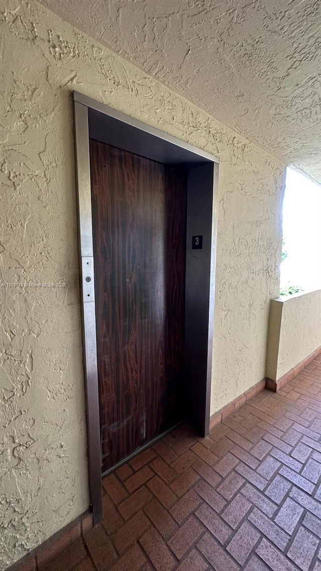 9455 W Flagler St Unit C308, Miami, FL 33174 - view of exterior entry featuring stucco siding and elevator