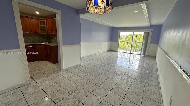 9455 W Flagler St Unit C308, Miami, FL 33174 - spare room featuring a wainscoted wall, light tile patterned flooring, a sink, and recessed lighting