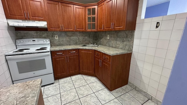 9455 W Flagler St Unit C308, Miami, FL 33174 - kitchen featuring electric range, under cabinet range hood, light tile patterned flooring, glass insert cabinets, and tile walls