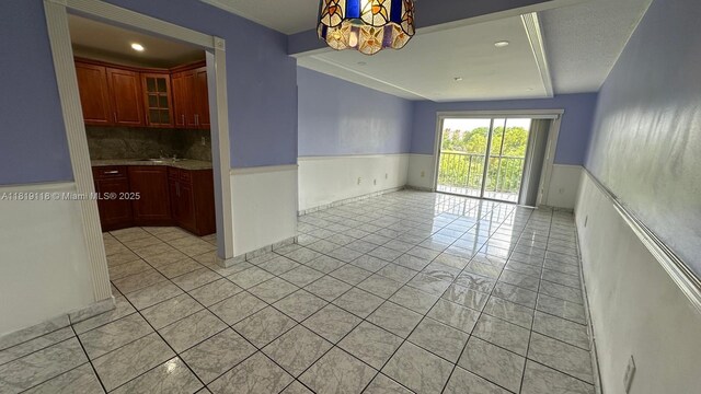 9455 W Flagler St Unit C308, Miami, FL 33174 - spare room featuring a wainscoted wall, light tile patterned flooring, a sink, and recessed lighting