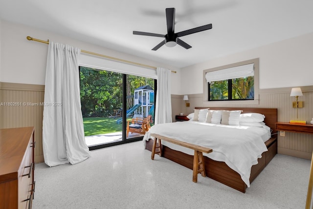 7921 SW 100th St, Miami, FL 33156 - bedroom with access to outside, wainscoting, multiple windows, a ceiling fan, and speckle patterned floor