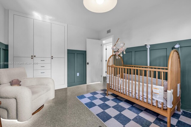 7921 SW 100th St, Miami, FL 33156 - bedroom featuring a decorative wall, wainscoting, and speckled floor
