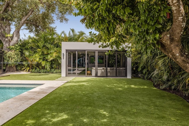 7921 SW 100th St, Miami, FL 33156 - rear view of house featuring an outdoor pool, a yard, an outdoor structure, and an exterior structure