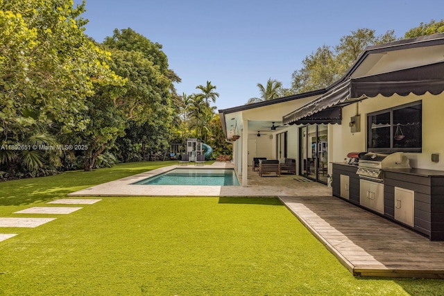 7921 SW 100th St, Miami, FL 33156 - swimming pool featuring exterior kitchen, a lawn, a ceiling fan, and a patio