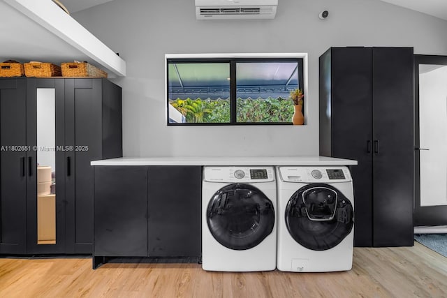 7921 SW 100th St, Miami, FL 33156 - laundry room with light wood finished floors, a wall unit AC, washing machine and clothes dryer, and cabinet space