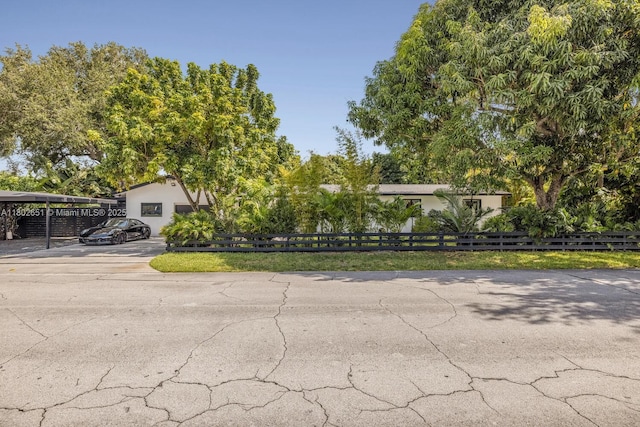7921 SW 100th St, Miami, FL 33156 - view of property hidden behind natural elements featuring concrete driveway