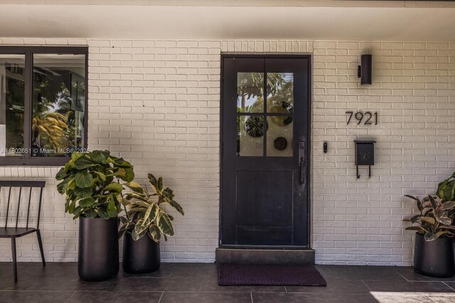 7921 SW 100th St, Miami, FL 33156 - doorway to property with brick siding