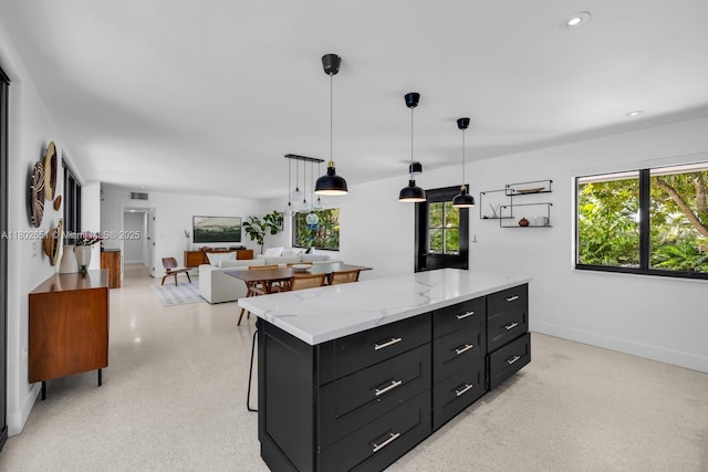 7921 SW 100th St, Miami, FL 33156 - kitchen featuring dark cabinets, pendant lighting, a center island, recessed lighting, and light stone counters