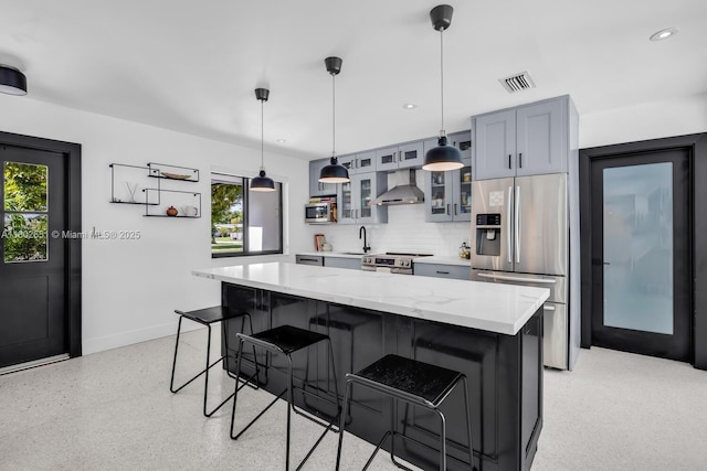7921 SW 100th St, Miami, FL 33156 - kitchen with appliances with stainless steel finishes, wall chimney range hood, a breakfast bar, plenty of natural light, and recessed lighting