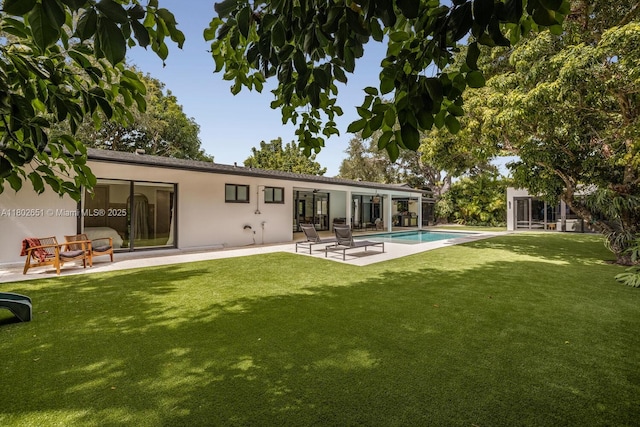 7921 SW 100th St, Miami, FL 33156 - back of property featuring a patio, a yard, an outdoor pool, and stucco siding